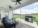 Covered patio with ceiling fans, outdoor seating, and views of a grassy fenced yard at 2048 Turnsberry Dr, Monroe, NC 28112