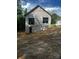 The unfinished basement entrance and newly installed windows show future potential, situated on a graded lot at 208 Malvern Sw Dr, Concord, NC 28025