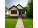Charming home featuring a manicured lawn, brick foundation, and welcoming front porch, creating an inviting curb appeal at 208 Malvern Sw Dr, Concord, NC 28025