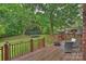 Expansive backyard with a wooden deck, lush lawn, mature trees, and privacy fencing at 20812 Decora Dr, Cornelius, NC 28031