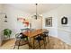 Elegant dining room with modern light fixture, table, and wainscoting at 20812 Decora Dr, Cornelius, NC 28031