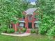 Beautiful two-story brick home with lush landscaping, a welcoming front entrance, and classic design at 20812 Decora Dr, Cornelius, NC 28031