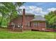 Beautiful brick home featuring a large deck and patio, perfect for outdoor entertaining at 20812 Decora Dr, Cornelius, NC 28031