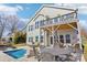 Beautiful backyard featuring a pool, lounge chairs, and a deck perfect for outdoor entertaining and enjoyment at 21610 Rio Oro Dr, Cornelius, NC 28031