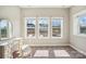 Bright bedroom featuring large windows with a view, and a simple desk with mirror at 21610 Rio Oro Dr, Cornelius, NC 28031