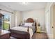 Charming bedroom features a decorative wood bed frame, neutral walls and carpet at 21610 Rio Oro Dr, Cornelius, NC 28031