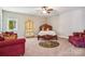 Spacious bedroom with carpet, dark wood furniture, and a view of the outside through the exterior window at 21610 Rio Oro Dr, Cornelius, NC 28031