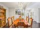 Bright dining room with a large wood table, chandelier, and artwork, ideal for Gathering meals at 21610 Rio Oro Dr, Cornelius, NC 28031