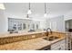 Bright kitchen features granite countertops, a stainless steel sink, and stylish pendant lighting at 21610 Rio Oro Dr, Cornelius, NC 28031