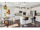 Bright kitchen with white cabinetry, granite countertops, stainless steel appliances, and a breakfast bar at 21610 Rio Oro Dr, Cornelius, NC 28031