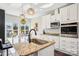 Kitchen island with granite countertops, stainless steel appliances, pendant lighting, and adjacent dining area at 21610 Rio Oro Dr, Cornelius, NC 28031