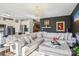 Elegant living room with a luxurious sectional, chandelier, dark accent wall, and hardwood floors at 21610 Rio Oro Dr, Cornelius, NC 28031