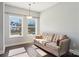 Sitting room with hardwood floors, a sofa, and large windows that allow for lots of natural light at 21610 Rio Oro Dr, Cornelius, NC 28031