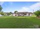 The backyard features an expansive lawn and charming home, ideal for relaxation and outdoor activities at 2632 Montford Nw Ave, Concord, NC 28027