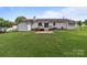 This backyard boasts a large lawn, a wood deck, and a charming home perfect for outdoor enjoyment and relaxation at 2632 Montford Nw Ave, Concord, NC 28027