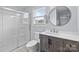 Bright bathroom featuring a glass shower and a rustic vanity with a sleek countertop at 2632 Montford Nw Ave, Concord, NC 28027