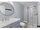 Charming bathroom with a blue vanity, marble countertop, and a curved glass shower at 2632 Montford Nw Ave, Concord, NC 28027