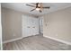 Bedroom with light gray walls, wood-look floors, a ceiling fan, and a white closet at 2632 Montford Nw Ave, Concord, NC 28027