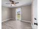 Bedroom with light gray walls, wood-look floors, and a window with sheer white curtains at 2632 Montford Nw Ave, Concord, NC 28027