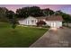 Charming single-story home with blue shutters, pristine lawn, and a convenient driveway for ample parking at 2632 Montford Nw Ave, Concord, NC 28027