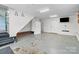 This is a large garage with stairs leading to the house, a storage cabinet, and a TV mounted on the wall at 2632 Montford Nw Ave, Concord, NC 28027