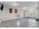 Garage area with a window, shelving, and a refrigerator perfect for extra storage or a workshop space at 2632 Montford Nw Ave, Concord, NC 28027