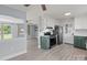 Open kitchen and dining area featuring gray floors, stainless steel appliances, and modern fixtures at 2632 Montford Nw Ave, Concord, NC 28027
