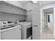 Laundry room with shelving and new, modern washer and dryer units, next to the hallway at 2632 Montford Nw Ave, Concord, NC 28027
