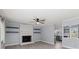 Cozy living room with fireplace, light gray floors, and open access to the kitchen at 2632 Montford Nw Ave, Concord, NC 28027