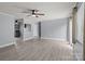 Spacious living area with light gray floors, painted wood paneling, and natural light at 2632 Montford Nw Ave, Concord, NC 28027