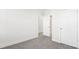 Bedroom with gray carpet, white walls, and an open closet space, offering simplicity and functionality at 279 Miramar Dr, York, SC 29745
