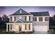 Charming two-story home boasts neutral siding, dark shutters, covered front porch, and an attached two-car garage at 279 Miramar Dr, York, SC 29745