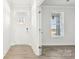 Bright foyer features a door with glass panes, light walls, and luxury vinyl plank flooring at 279 Miramar Dr, York, SC 29745