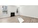 Bright living room with two windows, a fireplace, light walls, and luxury vinyl plank flooring at 279 Miramar Dr, York, SC 29745
