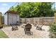 Backyard area with a shed and stone surround seating area with fire pit at 303 N Main N St, Granite Quarry, NC 28146