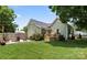 Backyard with a shed, stone surround seating area with fire pit, and green lawn at 303 N Main N St, Granite Quarry, NC 28146