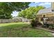 Green backyard with shed and seating, back porch, and a well-manicured lawn at 303 N Main N St, Granite Quarry, NC 28146