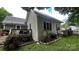 Home exterior with stone lined gardens and fenced backyard with deck at 303 N Main N St, Granite Quarry, NC 28146