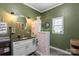 Charming green bathroom featuring a vanity with granite countertop and framed mirror at 303 N Main N St, Granite Quarry, NC 28146