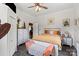 Bright bedroom with wooden ceiling, a ceiling fan, a bed, and rustic nightstands at 303 N Main N St, Granite Quarry, NC 28146