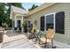 Inviting front porch with rocking chairs, bench, outdoor rug, and black shutters at 303 N Main N St, Granite Quarry, NC 28146