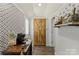 Hallway leading to rustic wood door, decorated with patterned wallpaper and dog-themed decor at 303 N Main N St, Granite Quarry, NC 28146