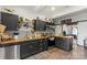 Modern kitchen featuring dark cabinetry, stainless appliances, open shelving, and butcher block countertops at 303 N Main N St, Granite Quarry, NC 28146