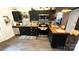 Stylish kitchen boasting black cabinets, butcher block countertops, stainless steel appliances, and designer backsplash at 303 N Main N St, Granite Quarry, NC 28146