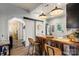 Kitchen with wood island, stainless appliances, white beadboard ceiling, and view to hallway with barn door at 303 N Main N St, Granite Quarry, NC 28146