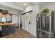 A modern kitchen featuring sleek cabinets, stainless steel refrigerator, and barn door at 303 N Main N St, Granite Quarry, NC 28146