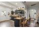 Well-lit kitchen with butcher block island, dark cabinetry, patterned backsplash, and stainless steel appliances at 303 N Main N St, Granite Quarry, NC 28146