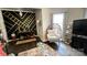 Stylish living room featuring decorative black accent wall, a cozy egg chair, and modern decor at 303 N Main N St, Granite Quarry, NC 28146