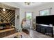 Well-lit living room featuring hardwood floors, neutral paint, and a comfortable egg chair at 303 N Main N St, Granite Quarry, NC 28146