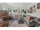 Spacious living room featuring hardwood floors, neutral paint, and a comfortable gray sectional sofa at 303 N Main N St, Granite Quarry, NC 28146